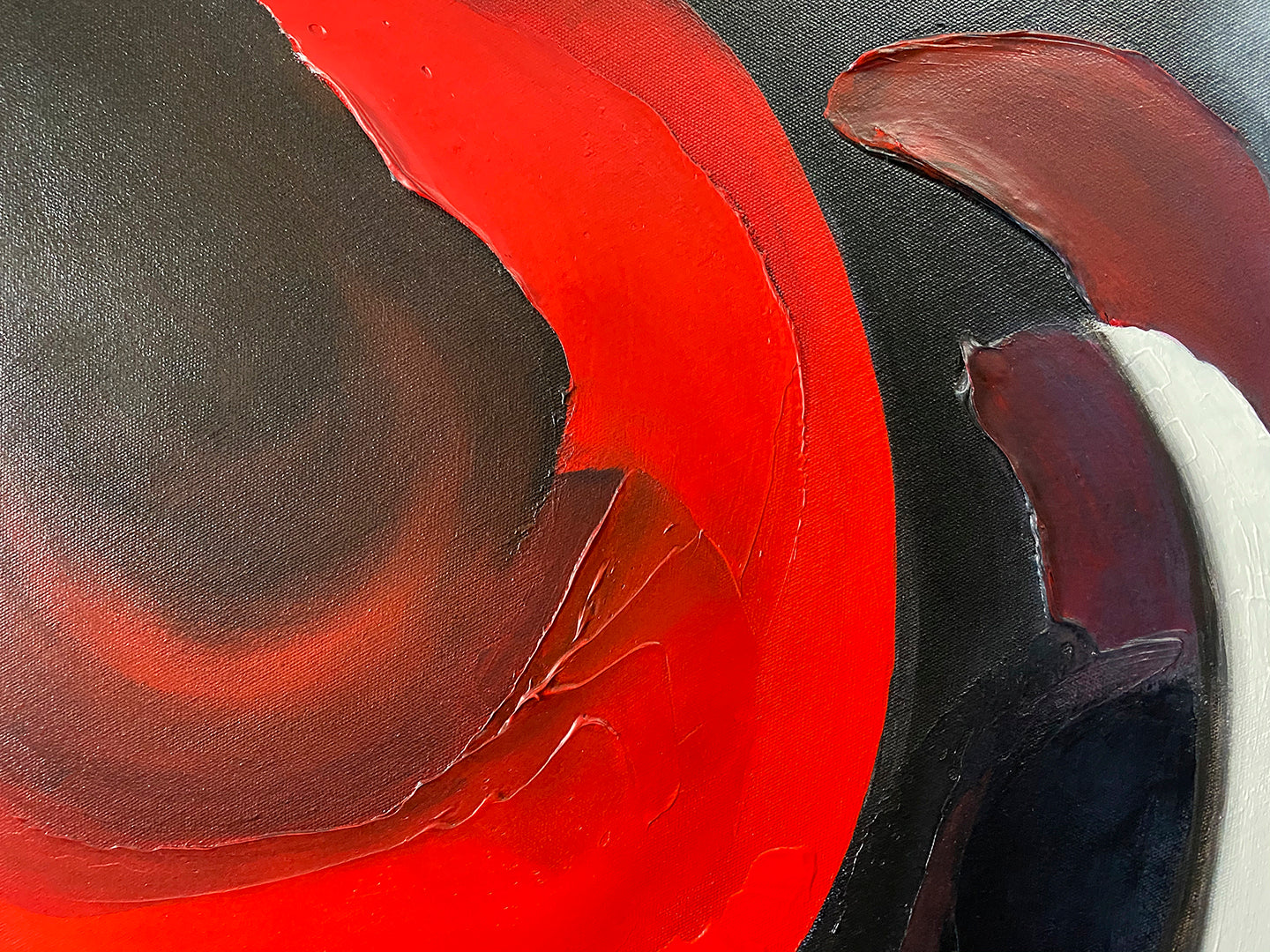 Abstract, acrylic and mixed-media painting close-up 2. texture paste, red, black, grey, and white acrylic paint on round canvas with curved-edges