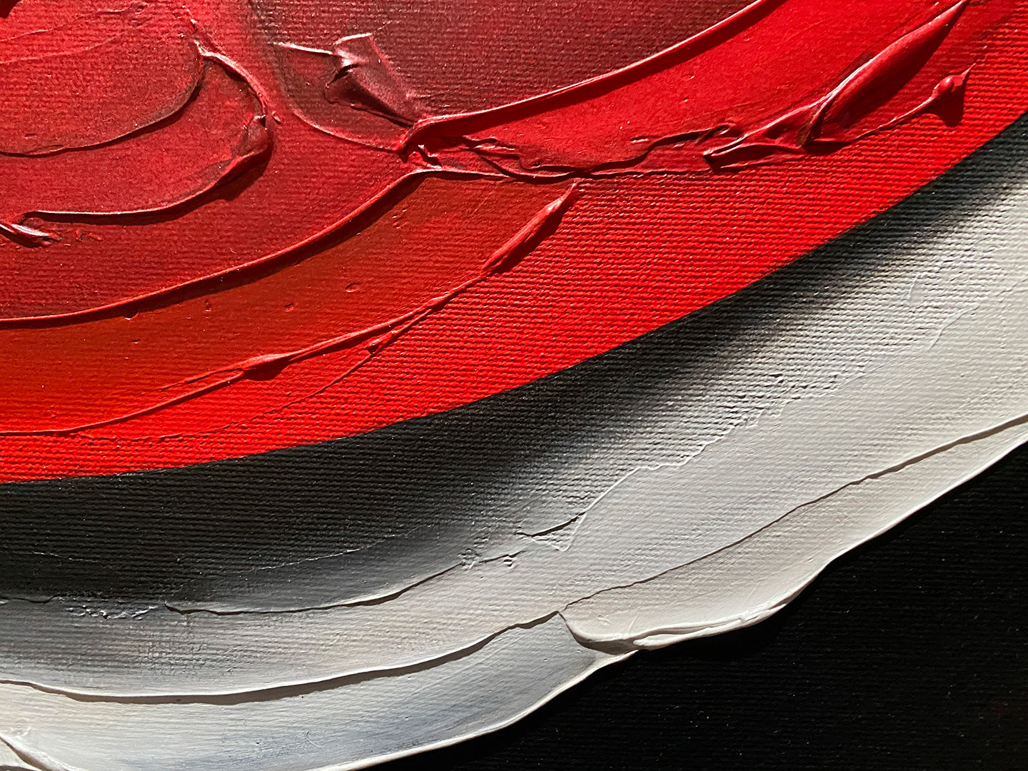 Abstract, acrylic and mixed-media painting close-up 2. texture paste, red, black, grey, and white acrylic paint on round canvas with curved-edges