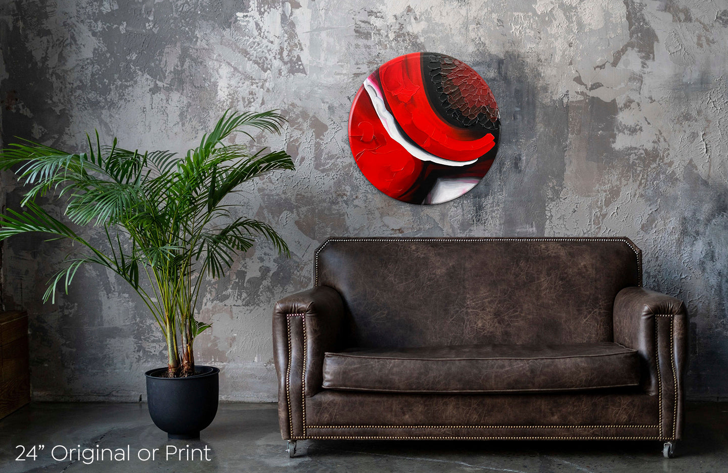 Abstract, acrylic and mixed-media 24” original or print on a round canvas with curved-edges shown on a dark grey, textured wall above a leather couch and plant.
