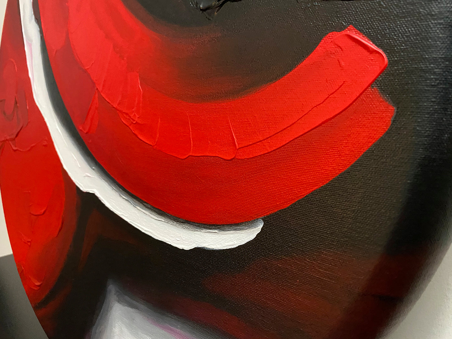 Abstract, acrylic and mixed-media painting close-up of the texture paste, red, black, grey, and white acrylic paint on round canvas focusing on the beautiful curved-edges 3