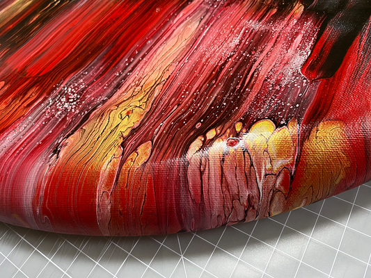 Abstract, acrylic and mixed-media painting close-up of the black, red, white and gold acrylic paint on round canvas focusing on the beautiful curved-edges