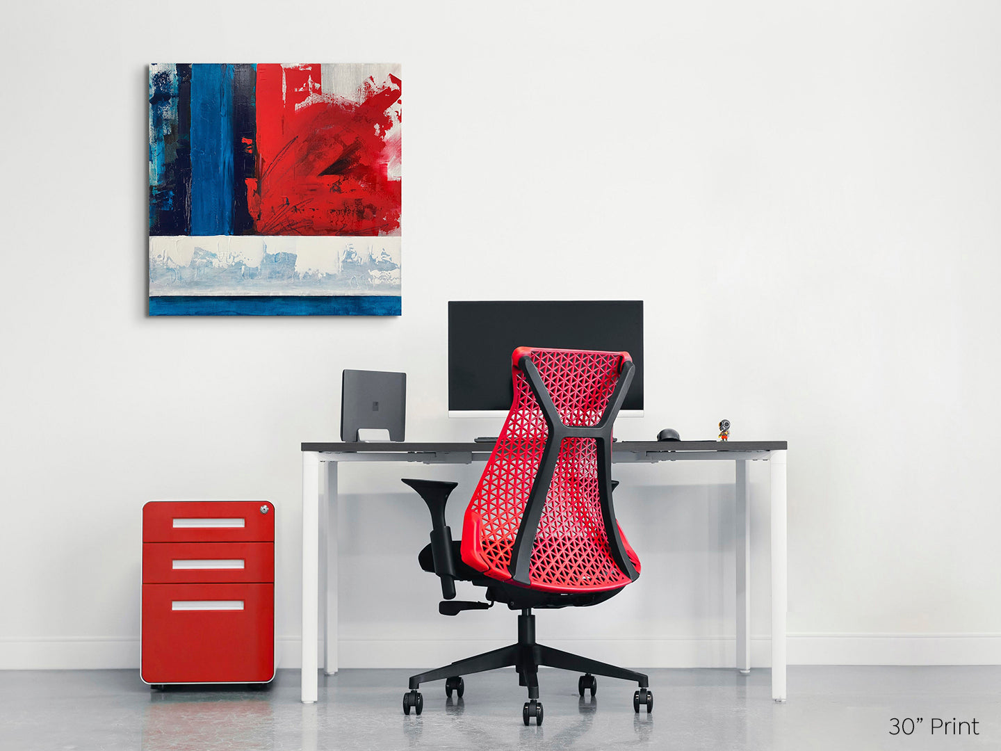 Abstract expressionism, acrylic print on a square gallery-wrapped canvas shown on a pale wall above a white desk with red filing cabinet and red chair