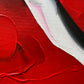 Abstract, acrylic and mixed-media painting close-up 1. texture paste, red, black, grey, and white acrylic paint on round canvas with curved-edges. 