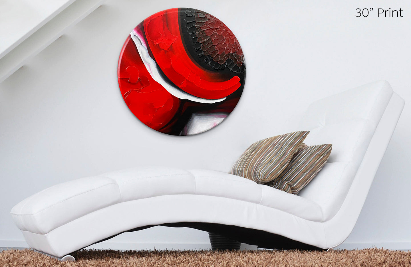 Abstract, acrylic and mixed-media 30” print on a round canvas with curved-edges shown on a white wall above a white chaise lounge.