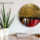 Abstract, acrylic and mixed-media painting on a round canvas with curved-edges shown on a pale cream wall above a desk