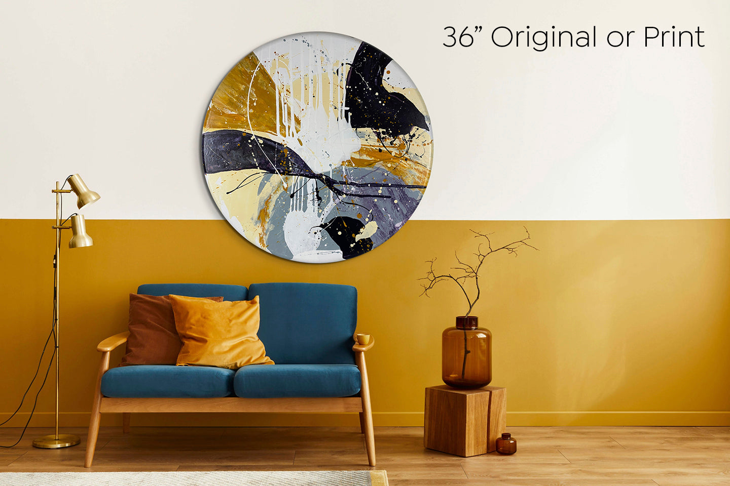 Abstract, acrylic painting on a round canvas with curved-edges shown on a wall with that is white above and ochre gold below with a teal couch