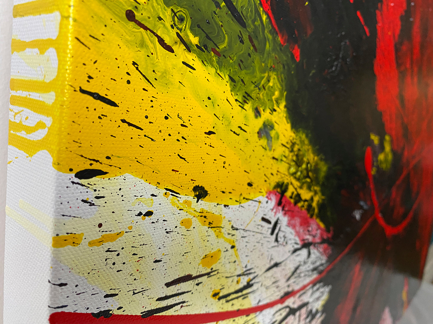 Abstract, expressionism, acrylic painting close-up showing the straight edge 1. Energetic explosion of bright red, black, yellow and white on a Gallery-Wrapped canvas